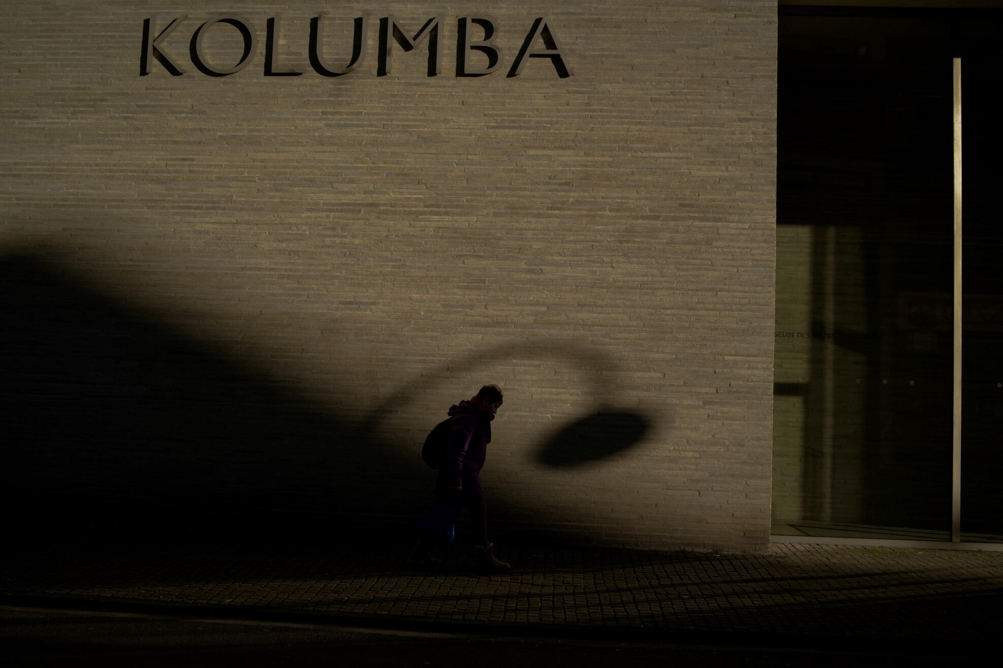 Shadow Move Street photograph of a pedestrian and dramatic shadows at Kolumba in Cologne by Franck Prevot
